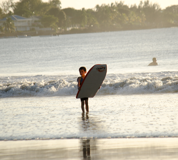 Catch your first waves on Tamarin Bay